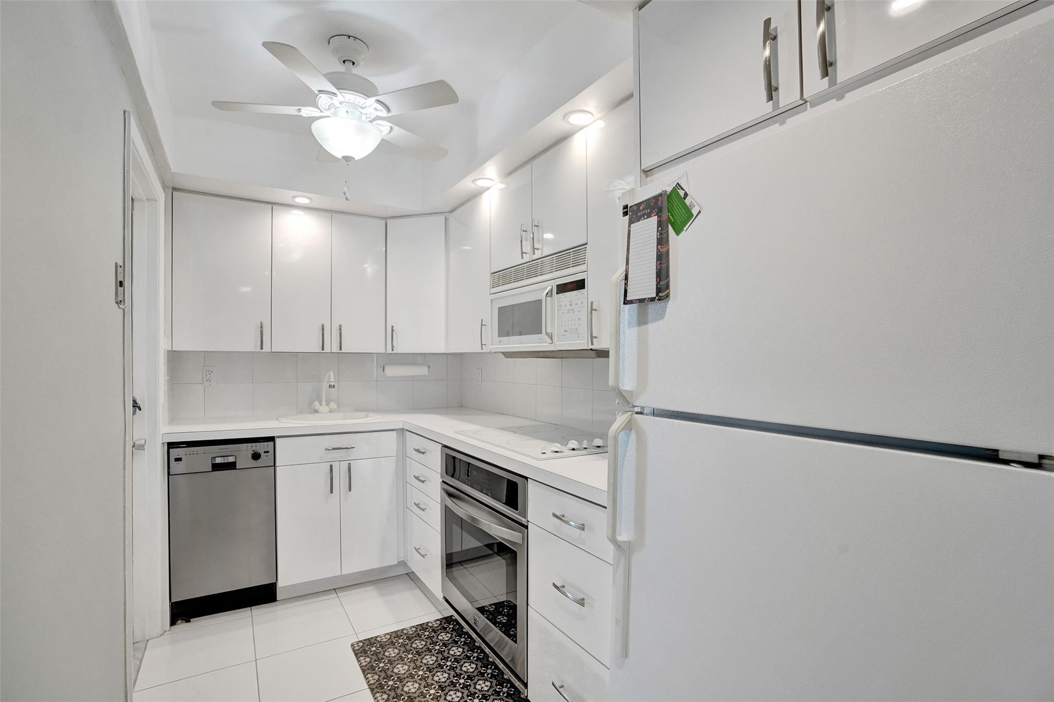 801 North Riverside Drive, Unit 4B Pompano Beach, FL 33062 - Photo 13 of 43 a kitchen with cabinets and stainless steel appliances