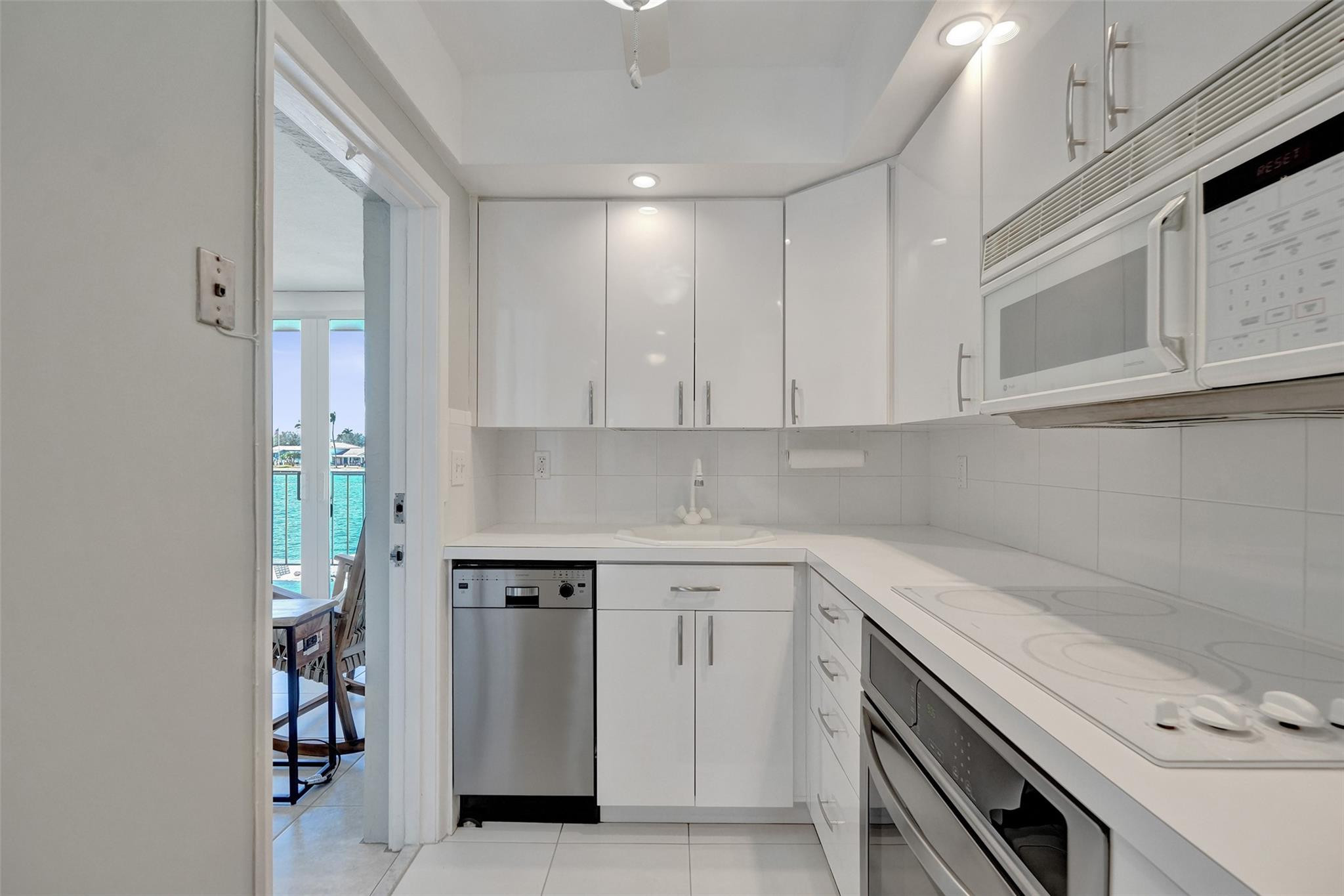 801 North Riverside Drive, Unit 4B Pompano Beach, FL 33062 - Photo 14 of 43 a view of a kitchen with white cabinets