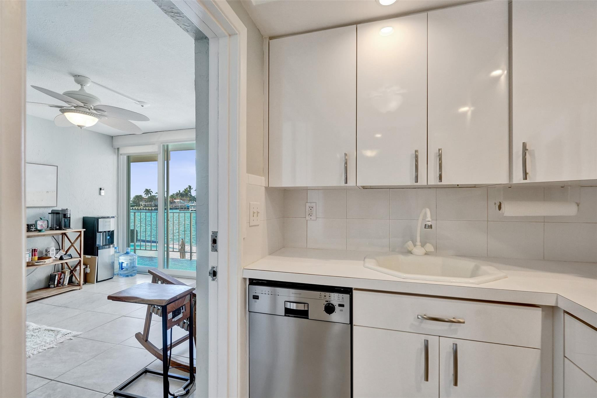 801 North Riverside Drive, Unit 4B Pompano Beach, FL 33062 - Photo 15 of 43 a kitchen with a sink cabinets and window