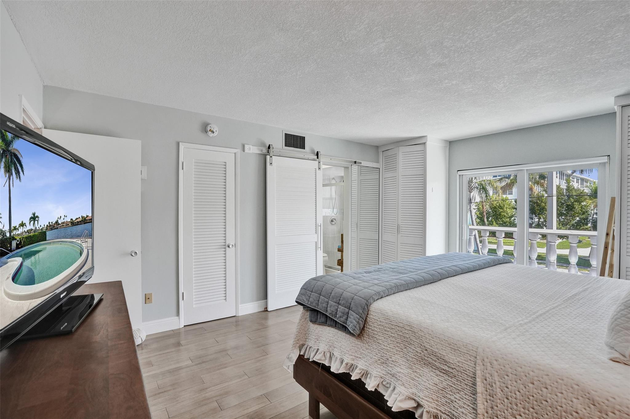 801 North Riverside Drive, Unit 4B Pompano Beach, FL 33062 - Photo 18 of 43 a bedroom with a bed and a window