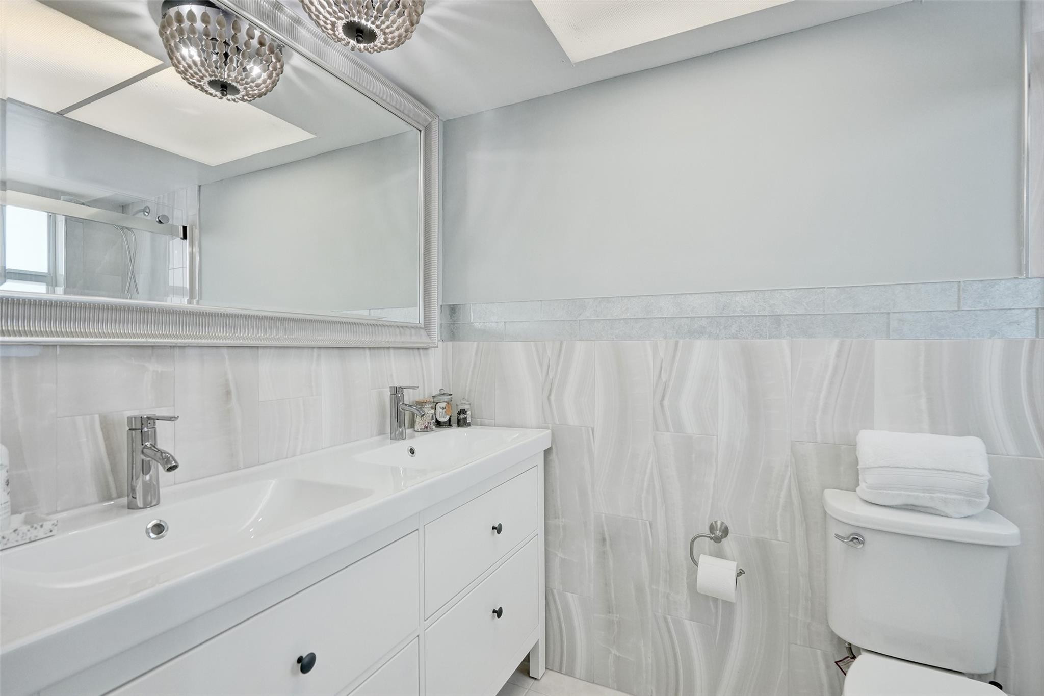 801 North Riverside Drive, Unit 4B Pompano Beach, FL 33062 - Photo 19 of 43 a bathroom with a sink vanity and mirror