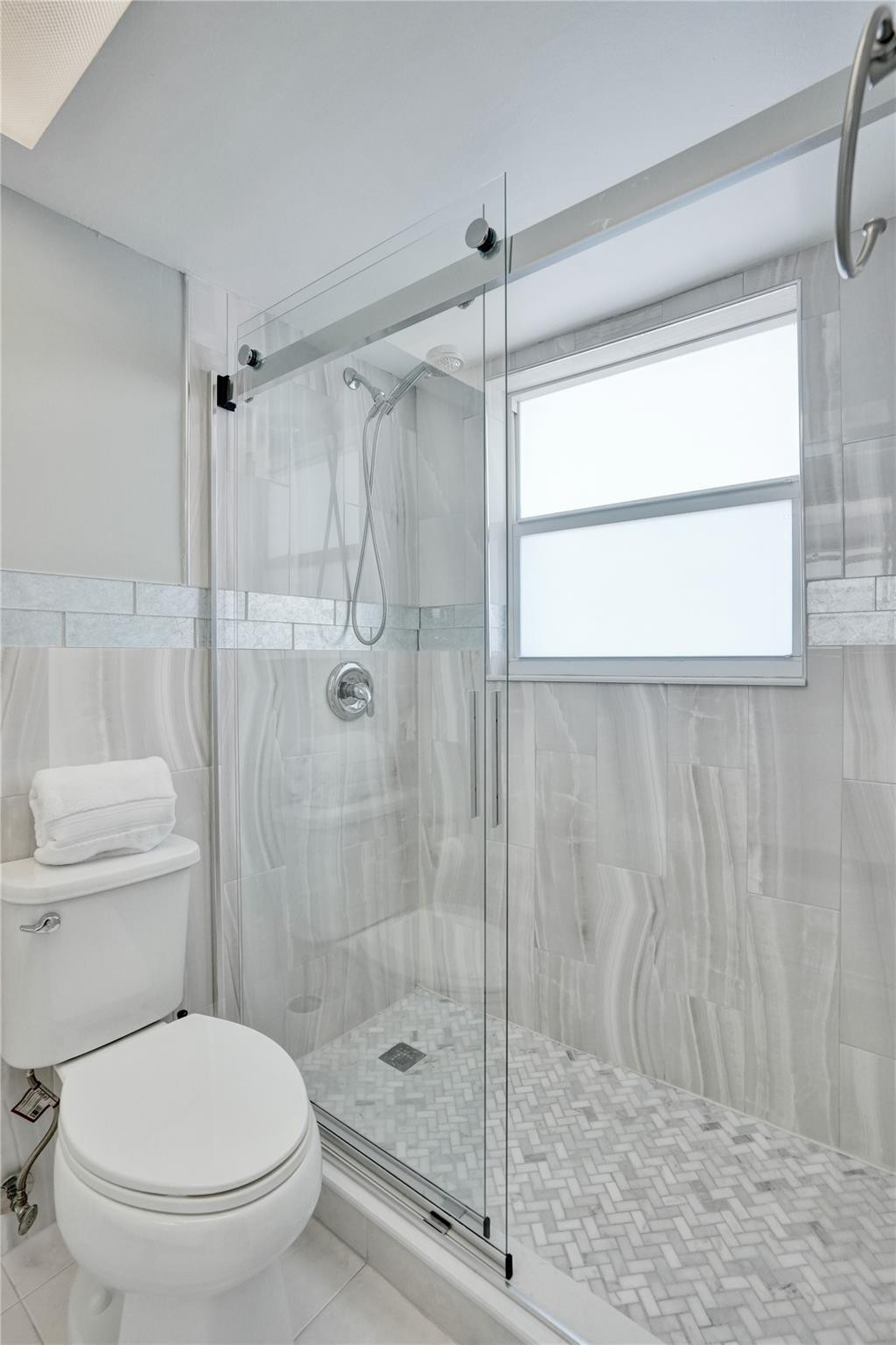 801 North Riverside Drive, Unit 4B Pompano Beach, FL 33062 - Photo 20 of 43 a bathroom with a shower and a toilet
