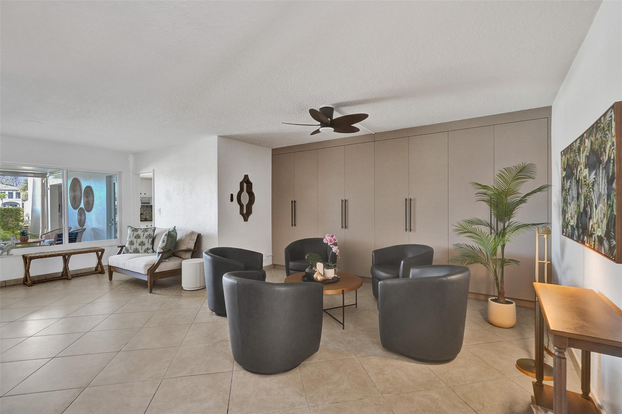801 North Riverside Drive, Unit 4B Pompano Beach, FL 33062 - Photo 32 of 43 a living room with furniture and a potted plant