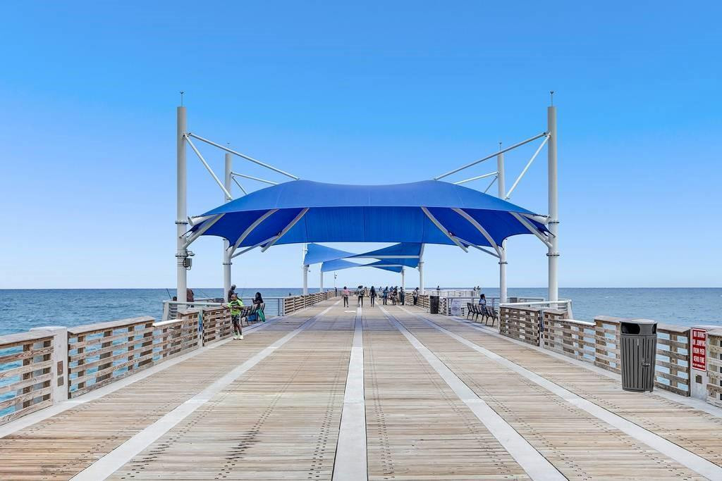 801 North Riverside Drive, Unit 4B Pompano Beach, FL 33062 - Photo 39 of 43 a patio with swimming pool table and chairs