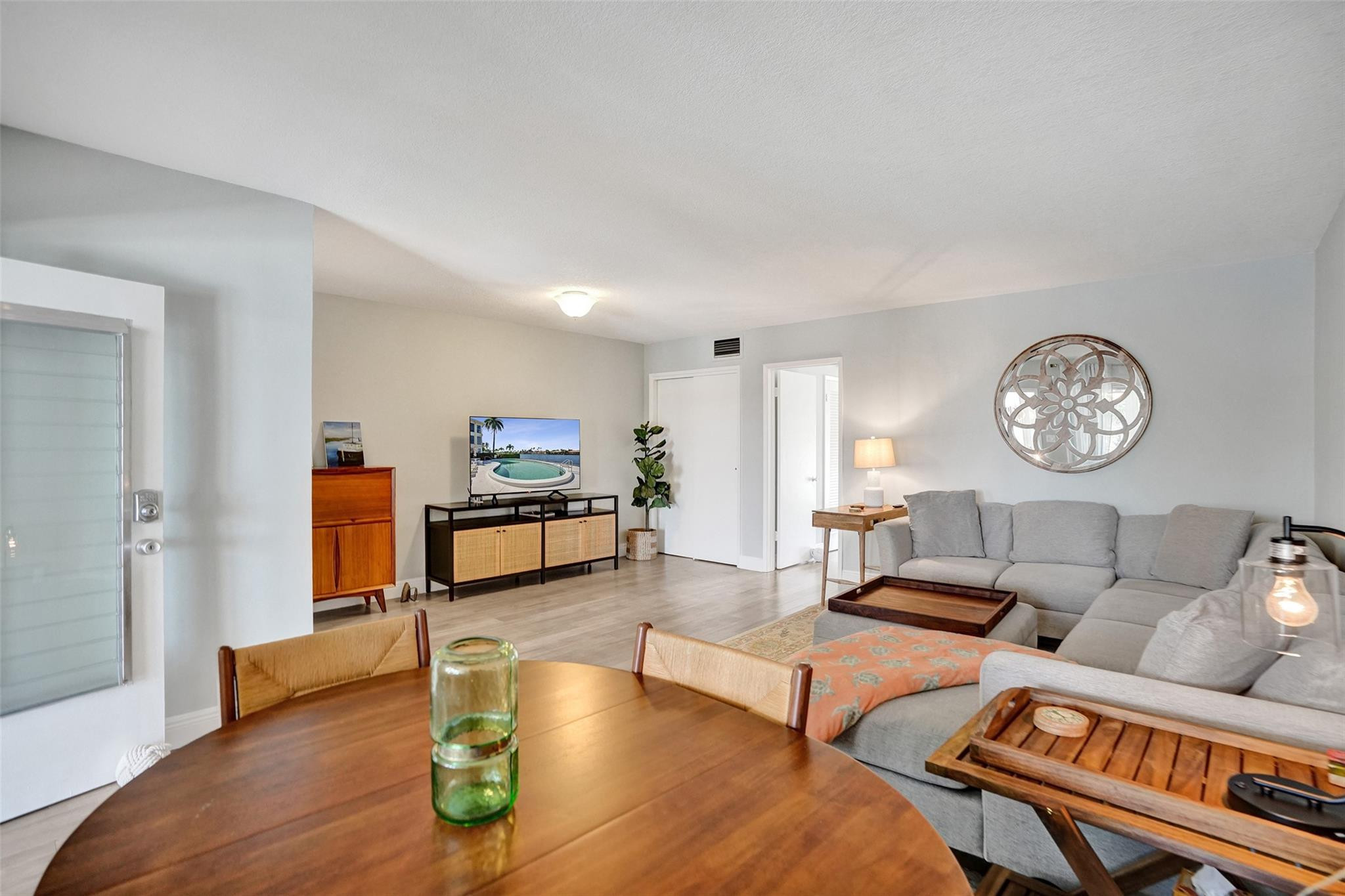 801 North Riverside Drive, Unit 4B Pompano Beach, FL 33062 - Photo 8 of 43 a living room with furniture a rug and a wooden floor