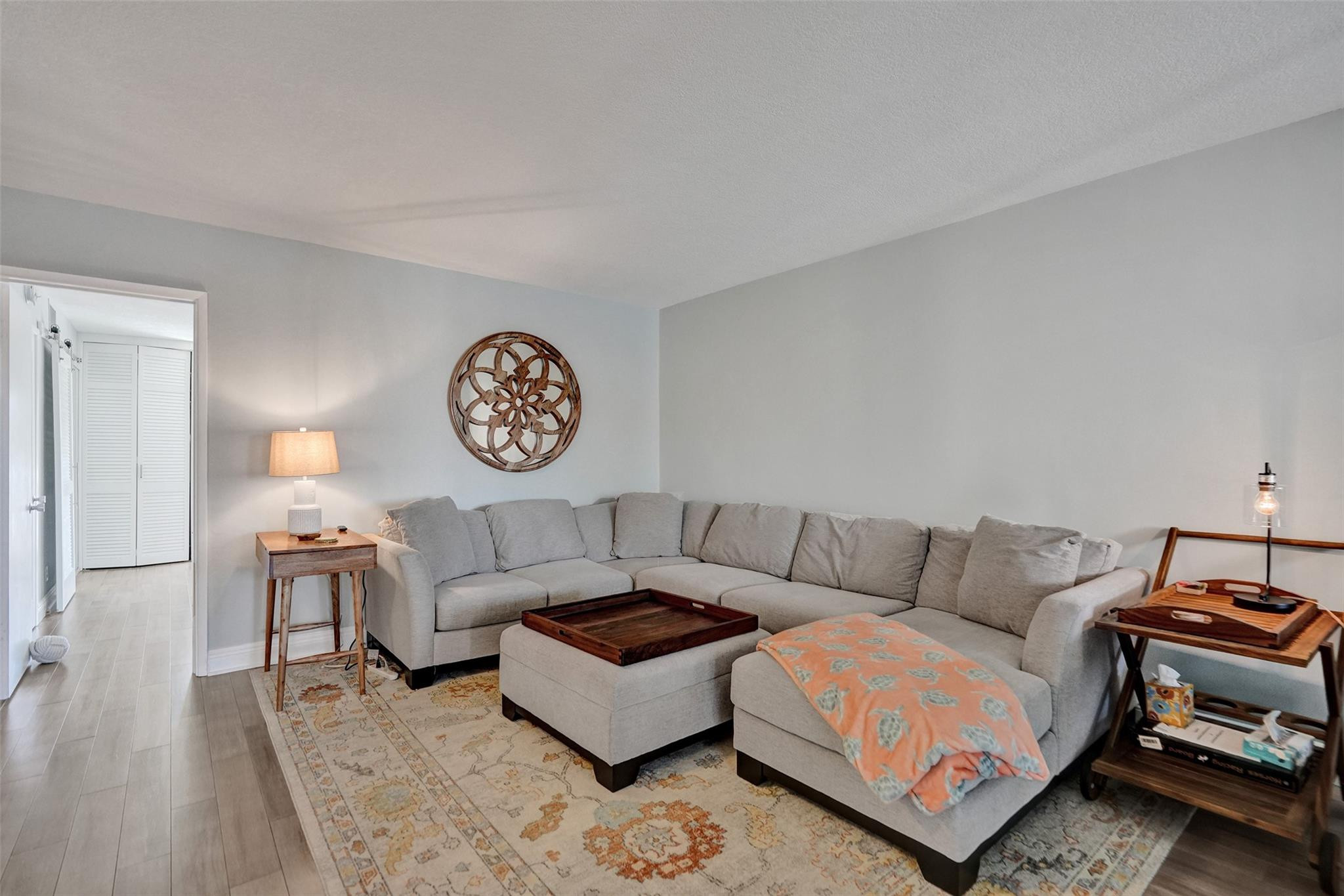 801 North Riverside Drive, Unit 4B Pompano Beach, FL 33062 - Photo 9 of 43 a living room with furniture a rug and a wall painting