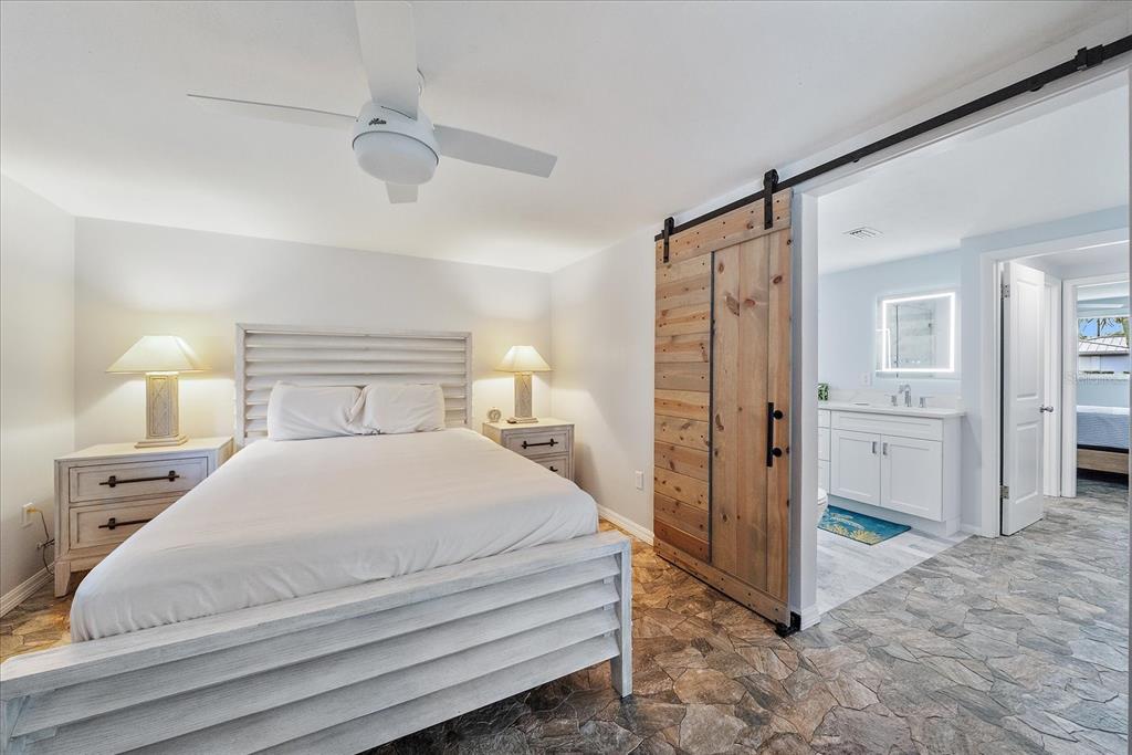 2431 Bispham Road Sarasota, FL 34231 - Photo 15 of 25 a bedroom with a bed and a refrigerator