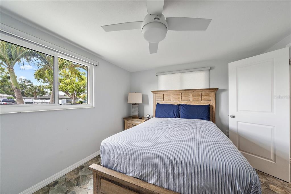 2431 Bispham Road Sarasota, FL 34231 - Photo 18 of 25 a bed sitting in a bedroom next to a window