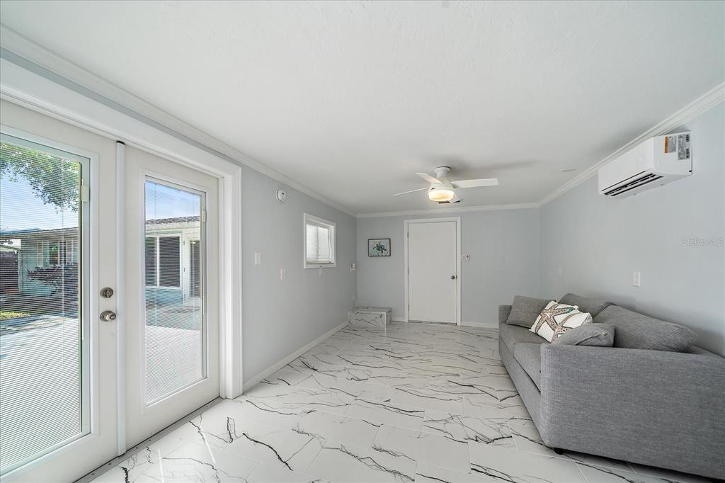 2431 Bispham Road Sarasota, FL 34231 - Photo 22 of 25 a living room with furniture and a ceiling fan
