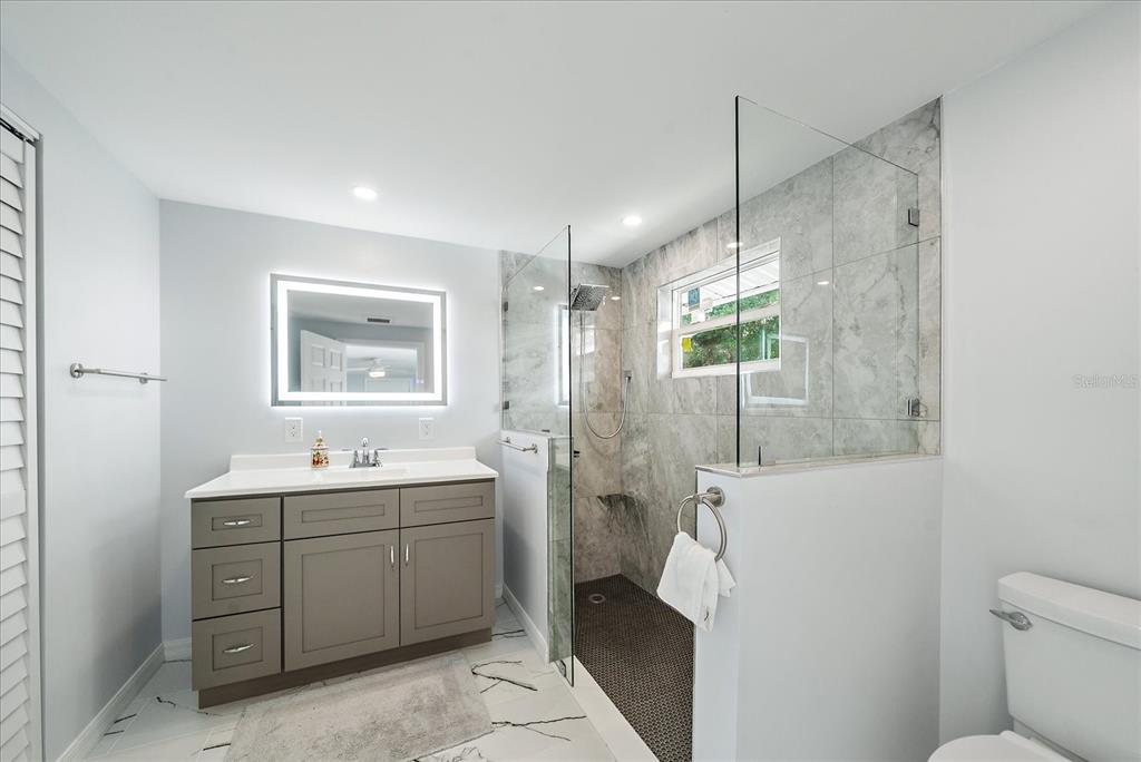 2431 Bispham Road Sarasota, FL 34231 - Photo 23 of 25 a bathroom with a toilet sink and mirror