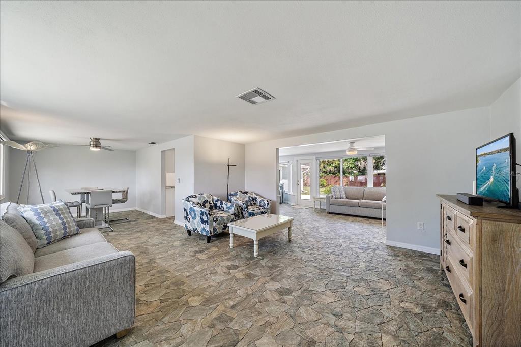 2431 Bispham Road Sarasota, FL 34231 - Photo 4 of 25 a living room with furniture and a flat screen tv