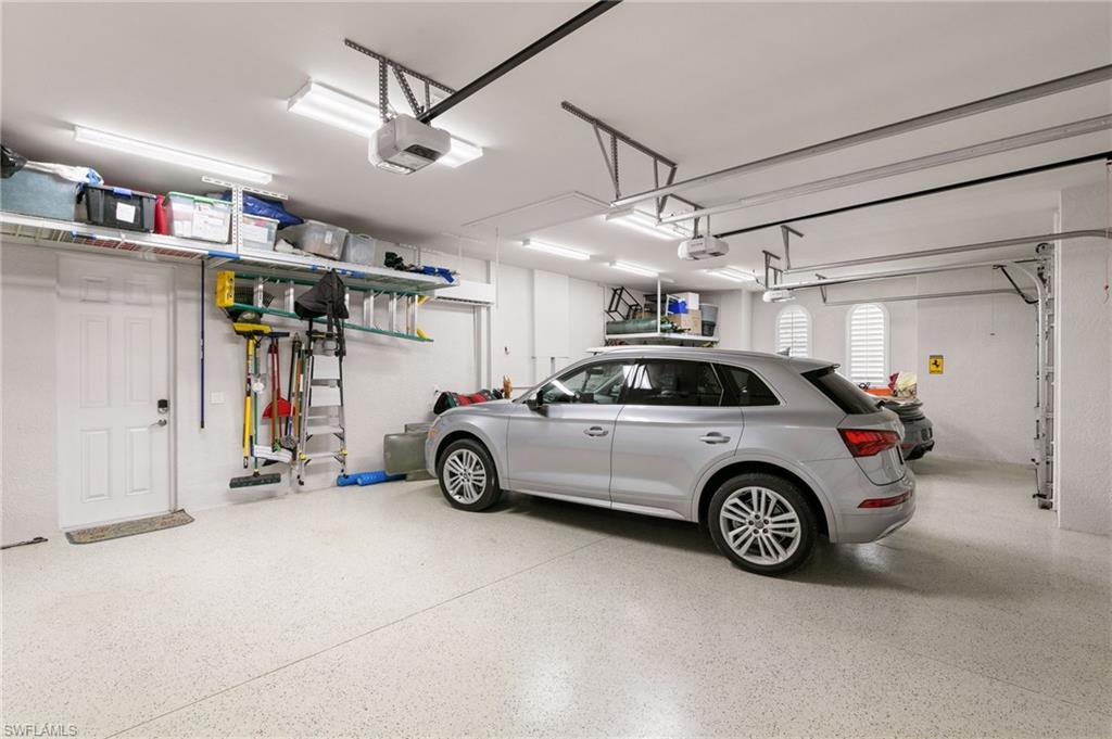 5903 Burnham Road Naples, FL 34119 - Photo 32 of 38 a view of a garage and car parked