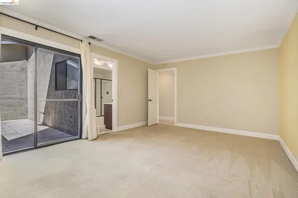 an empty room with sliding glass door