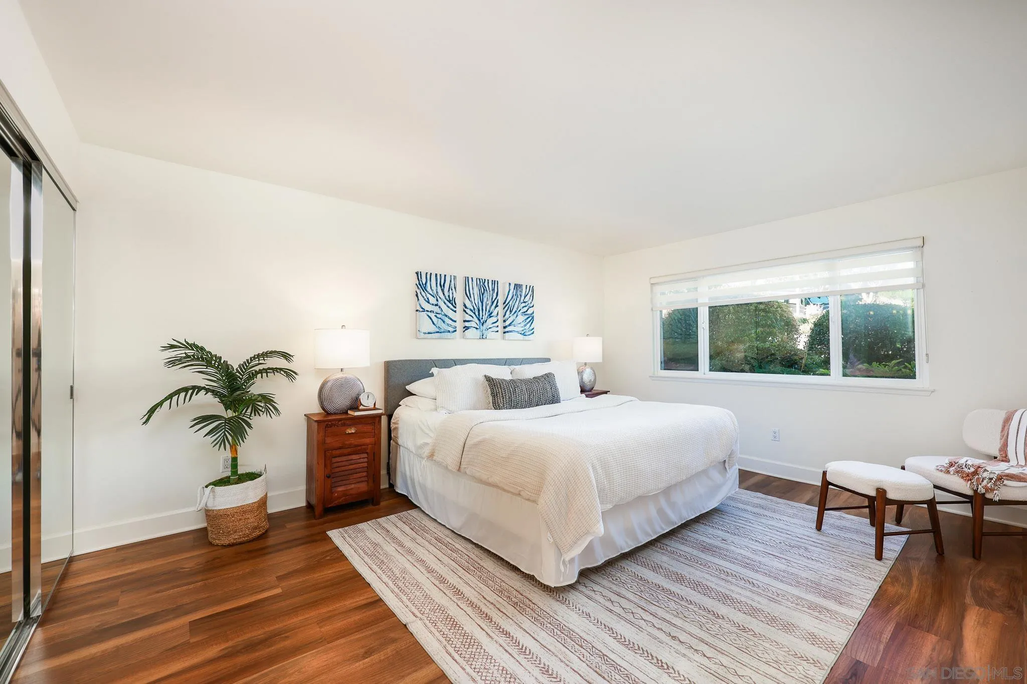 234 Turf View Drive Solana Beach, CA 92075 - Photo 11 of 29 a bedroom with a large bed wooden floor and a window