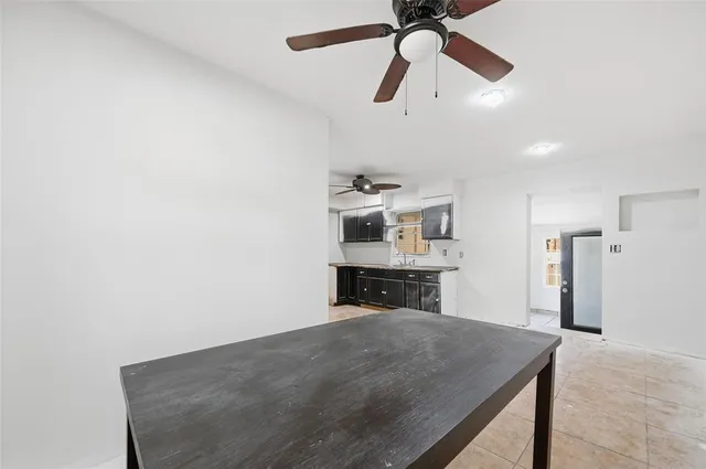 a kitchen with kitchen island stainless steel appliances a sink and cabinets