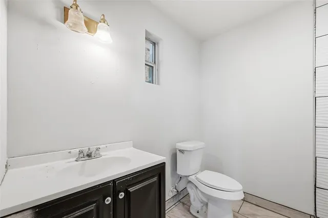 a bathroom with a sink a toilet and a mirror