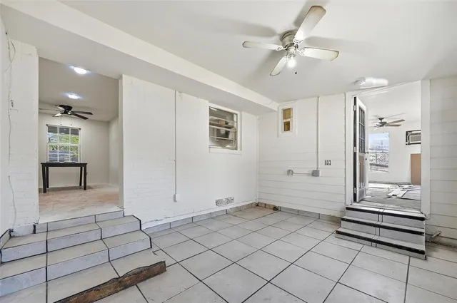 a view of a livingroom with furniture and a ceiling fan