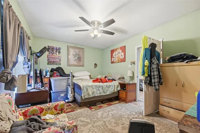 a bedroom with bed and furniture