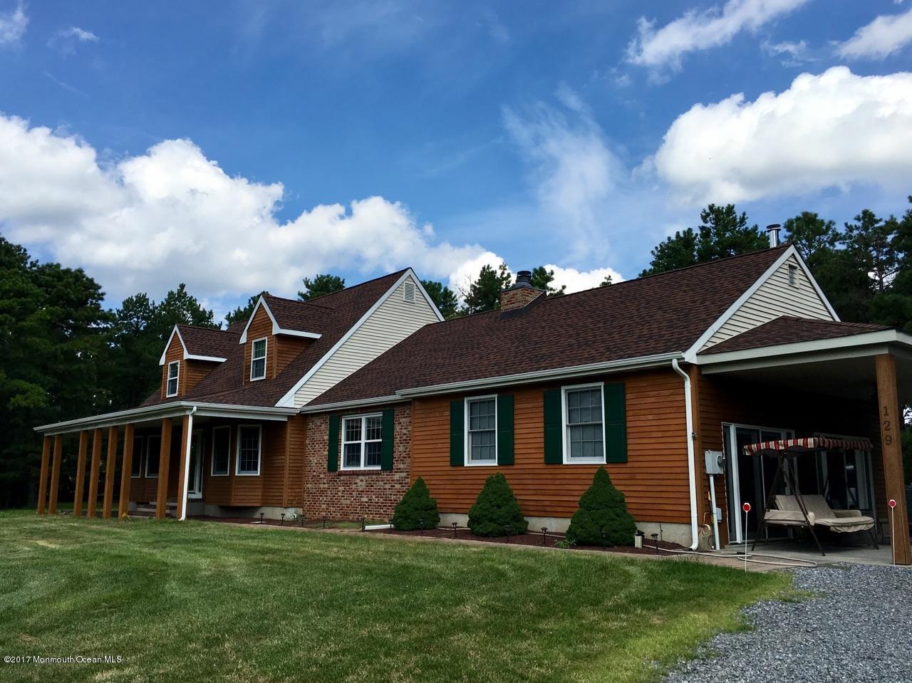 129 Frank Applegate Road Jackson, NJ 08527 - Photo 2 of 28 a front view of a house with a garden and yard