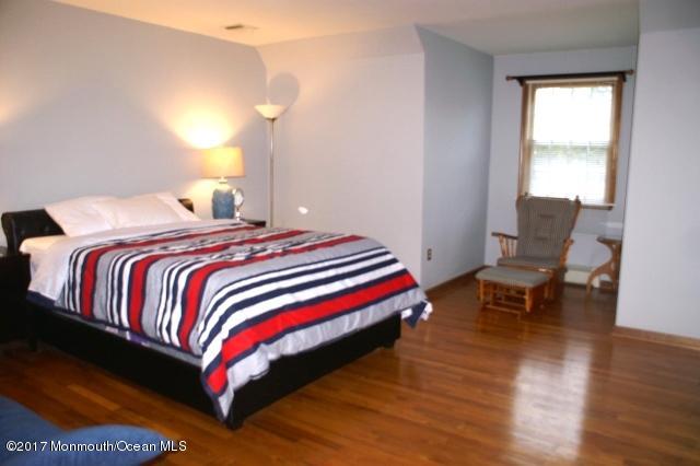 129 Frank Applegate Road Jackson, NJ 08527 - Photo 22 of 28 a bedroom with a bed and chair
