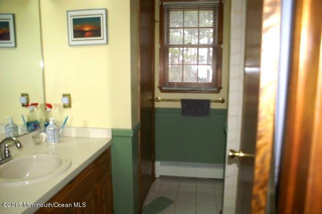 129 Frank Applegate Road Jackson, NJ 08527 - Photo 23 of 28 a bathroom with a sink and a mirror