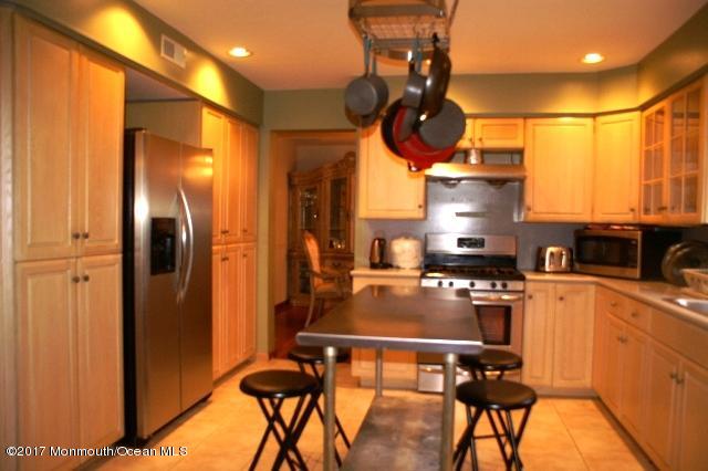 129 Frank Applegate Road Jackson, NJ 08527 - Photo 8 of 28 a kitchen with stainless steel appliances a stove a refrigerator and cabinets