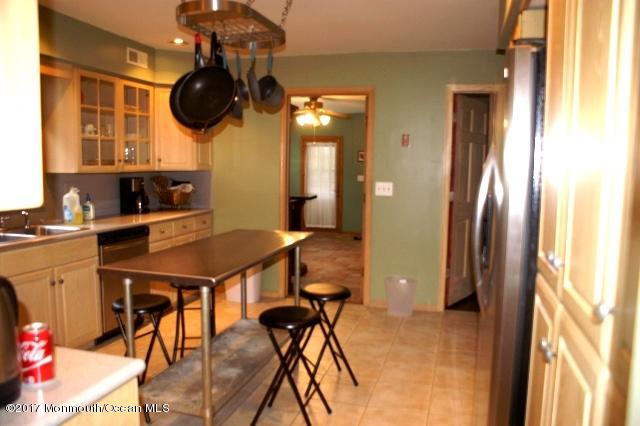 129 Frank Applegate Road Jackson, NJ 08527 - Photo 9 of 28 a kitchen with a table and a refrigerator