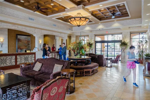 a living room with lots of furniture and a chandelier