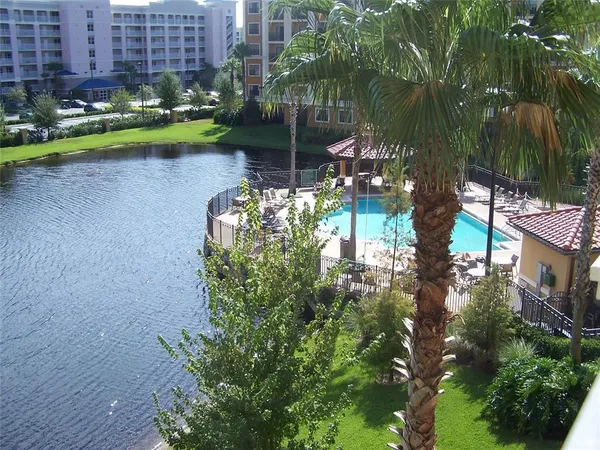 a green field with lots of flowers and trees