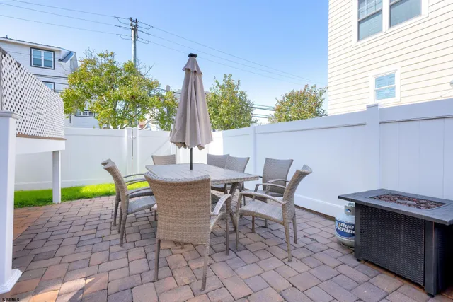 a view of a patio with a table and chairs