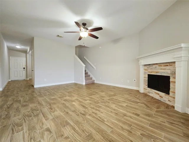 a view of empty room with a fireplace
