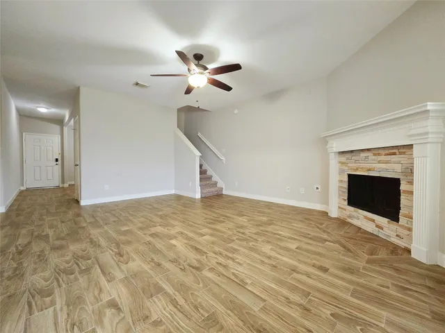 a view of empty room with a fireplace