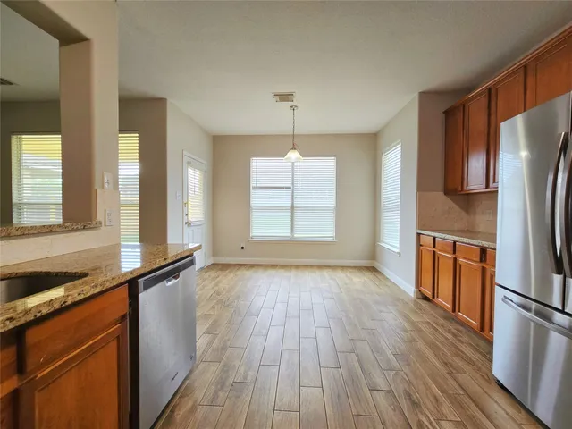 a empty room with wooden floor and window
