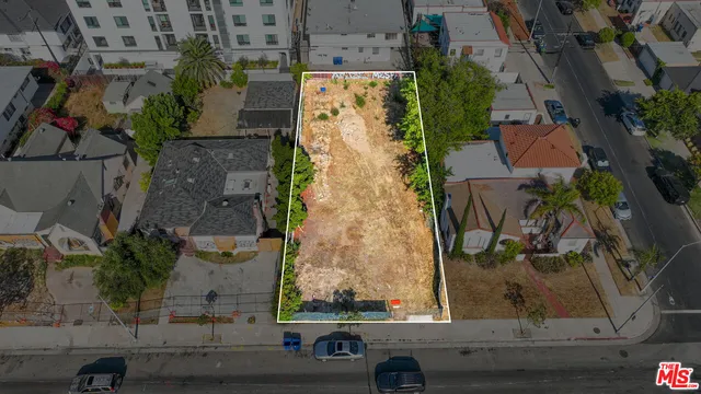 an aerial view of a residential houses with outdoor space