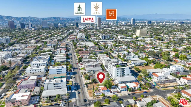 an aerial view of city and parking space