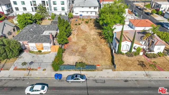 an aerial view of a building with garden space and street view