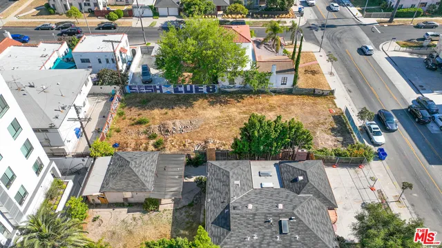 an aerial view of a house with a garden and lake view