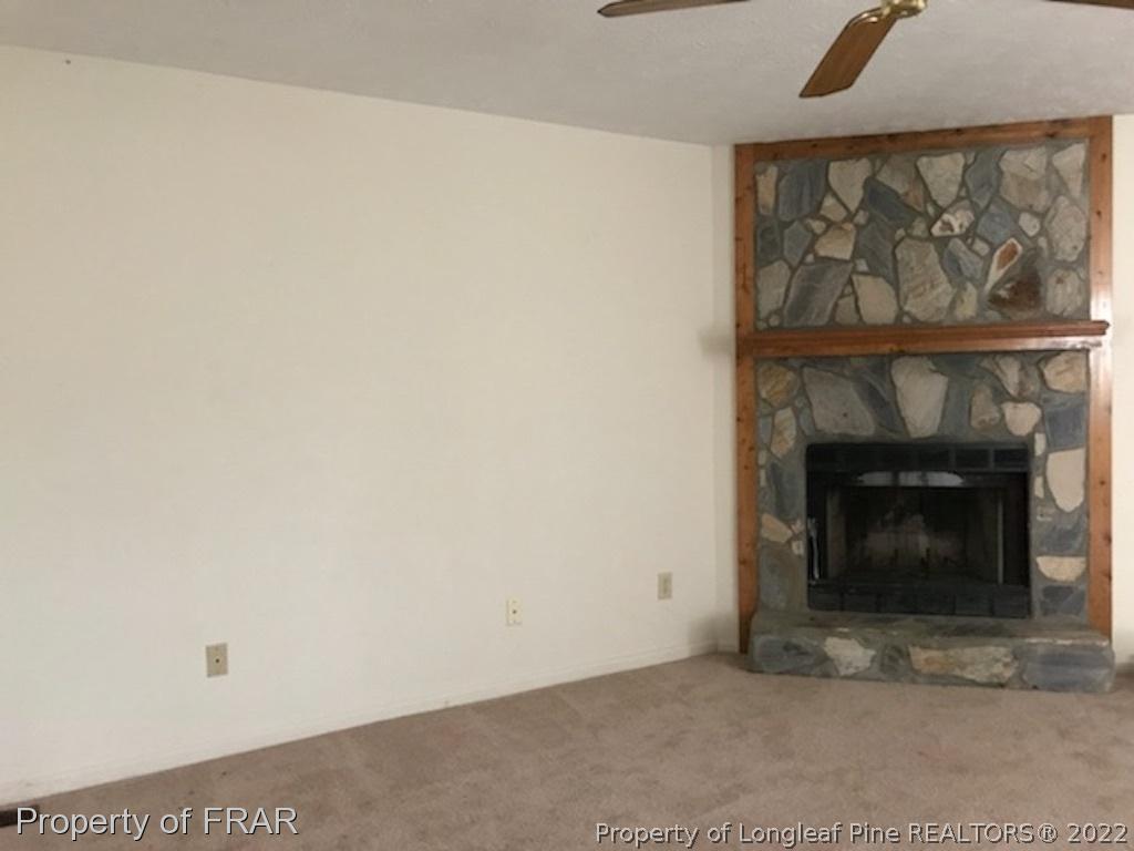 6548 Applewhite Road Fayetteville, NC 28304 - Photo 3 of 10 a view of an empty room with a fireplace