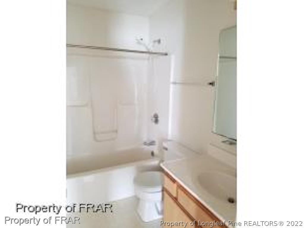 6548 Applewhite Road Fayetteville, NC 28304 - Photo 7 of 10 a bathroom with a bathtub and a toilet