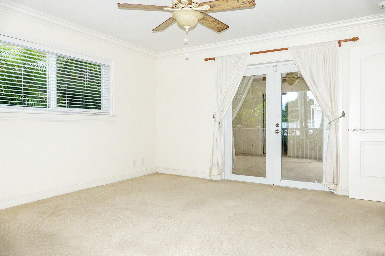 18014 Perigon Way Jupiter, FL 33458 - Photo 14 of 35 an empty room with a window and a chandelier fan