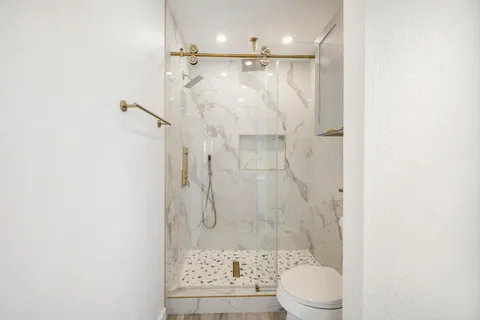 a bedroom with a bed and a painting on the wall