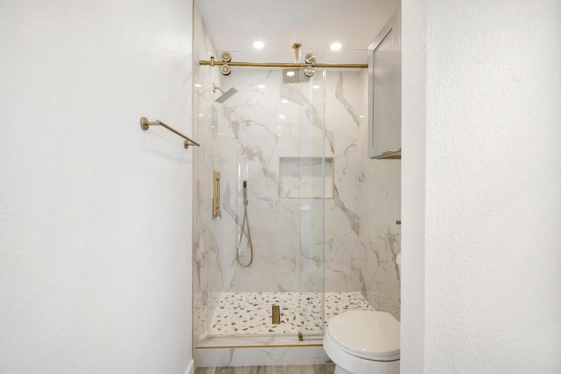 13501 Sierra Wind Lane Elgin, TX 78621 - Photo 19 of 31 Bathroom with toilet and a marble finish shower