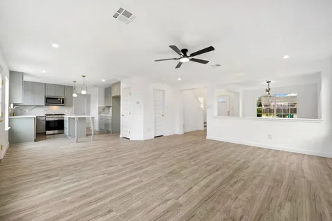 a living room with furniture potted plant and window