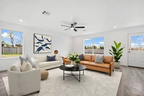 a kitchen with a refrigerator a dining table and chairs