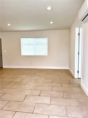 a view of a room with an empty space and a window