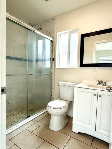 a bathroom with a toilet sink and a mirror