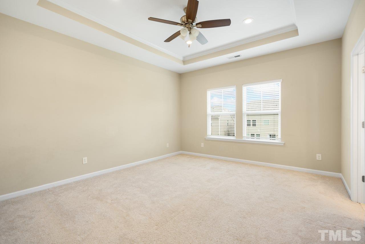 2433 Pilsley Road Apex, NC 27539 - Photo 14 of 28 an empty room with windows and fan