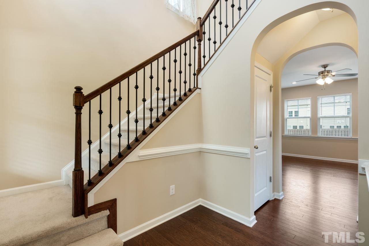 2433 Pilsley Road Apex, NC 27539 - Photo 3 of 28 a view of staircase with wooden floor and a potted plant