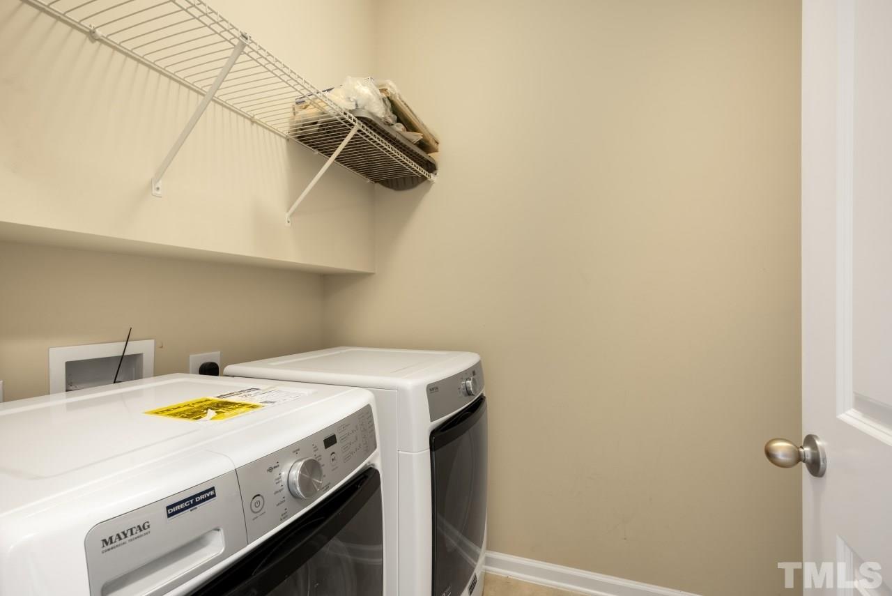 2433 Pilsley Road Apex, NC 27539 - Photo 23 of 28 a view of storage and utility room with racks on the wall