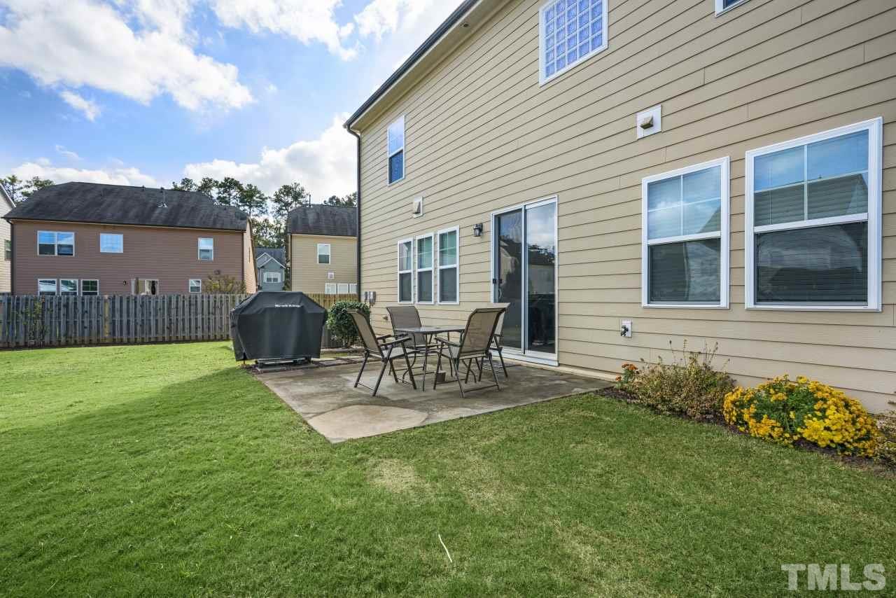 2433 Pilsley Road Apex, NC 27539 - Photo 26 of 28 a view of a chair and table in backyard of the house